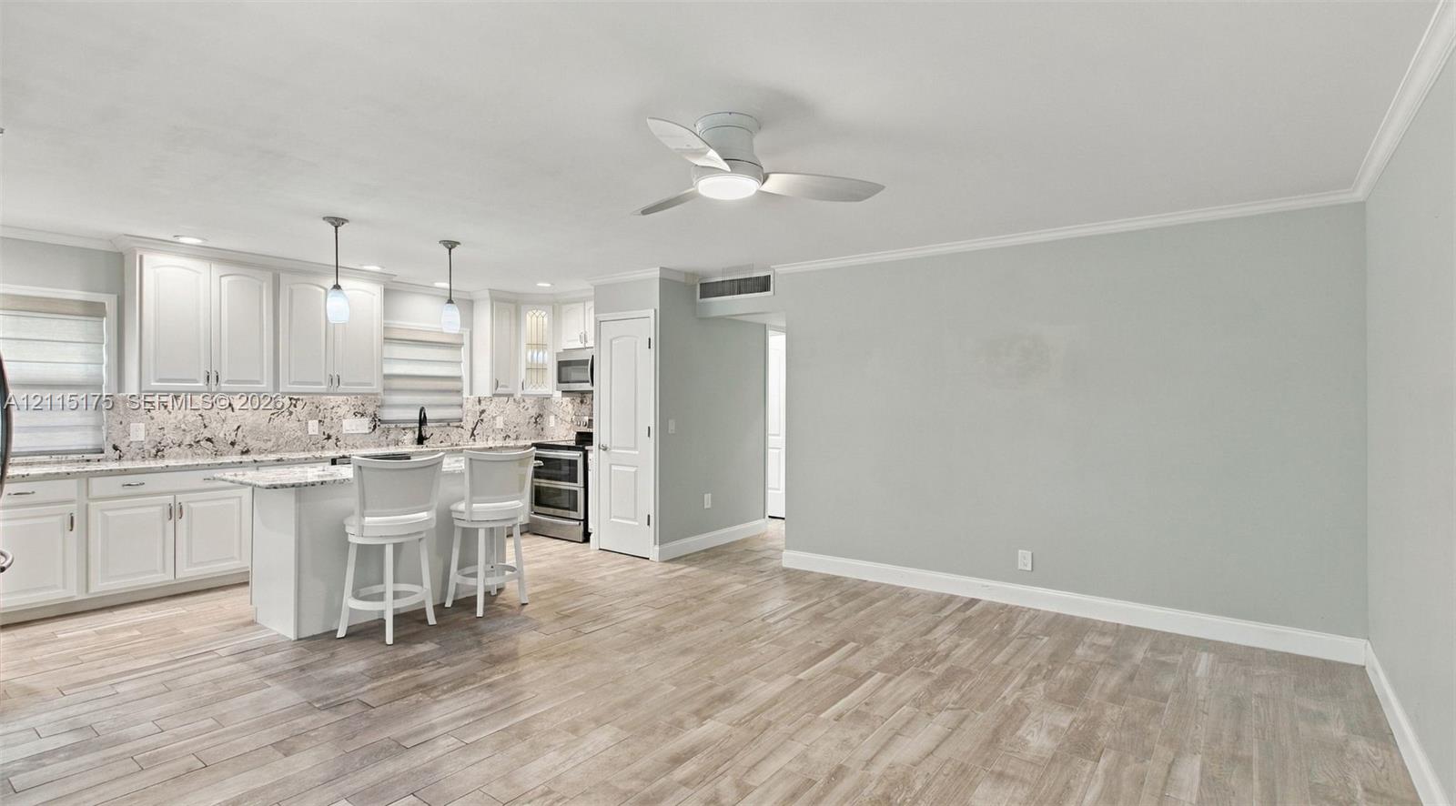 Open concept living area with porcelain tile wood-look flooring
