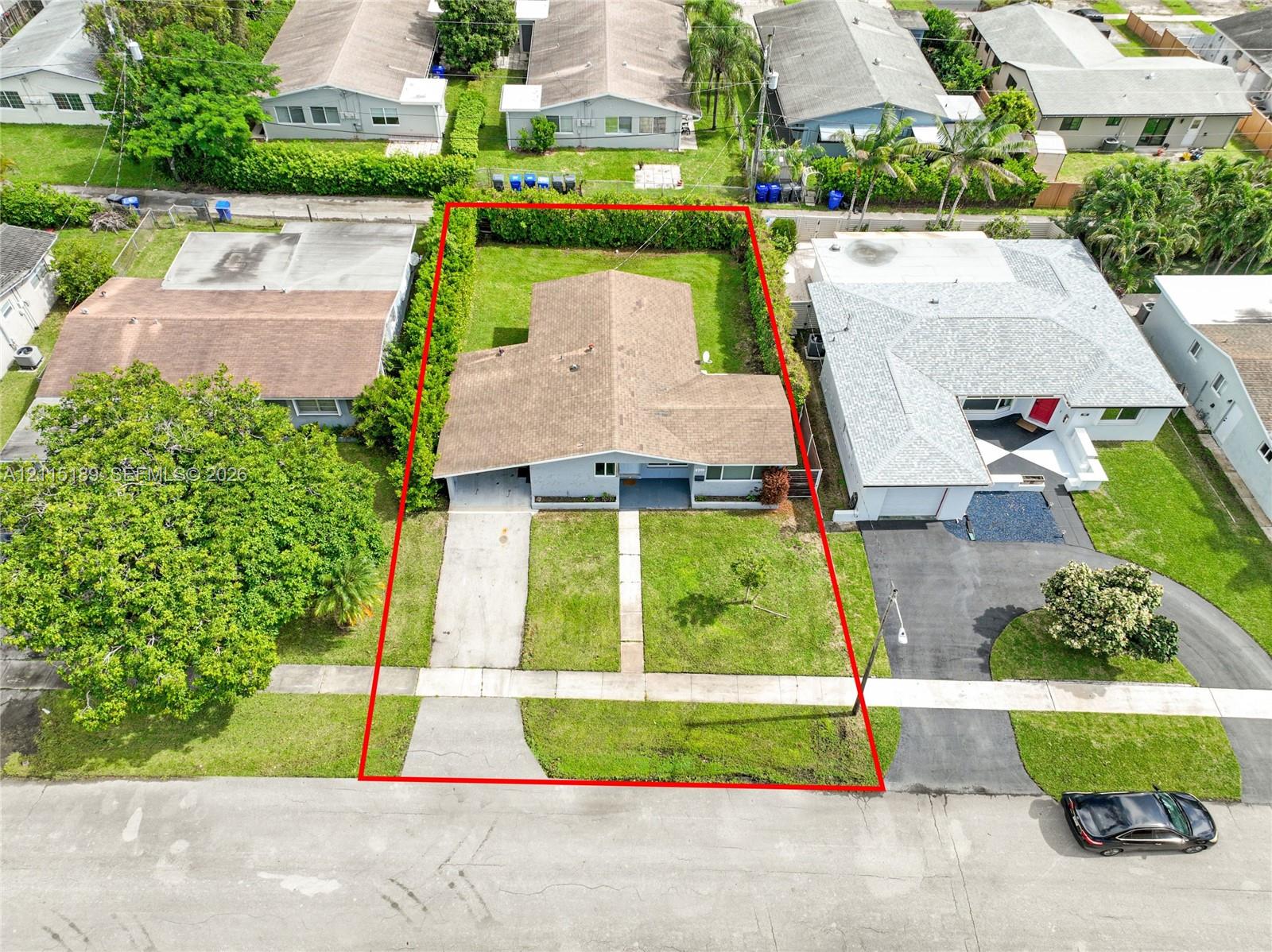 Single-story residence featuring a concrete driveway, structured landscaping, and a manicured lawn Single-story residence featuring a concrete driveway, structured landscaping, and a manicured lawn