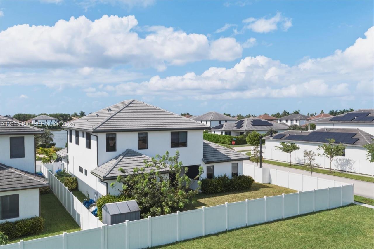 Rear aerial view of the fenced backyard.