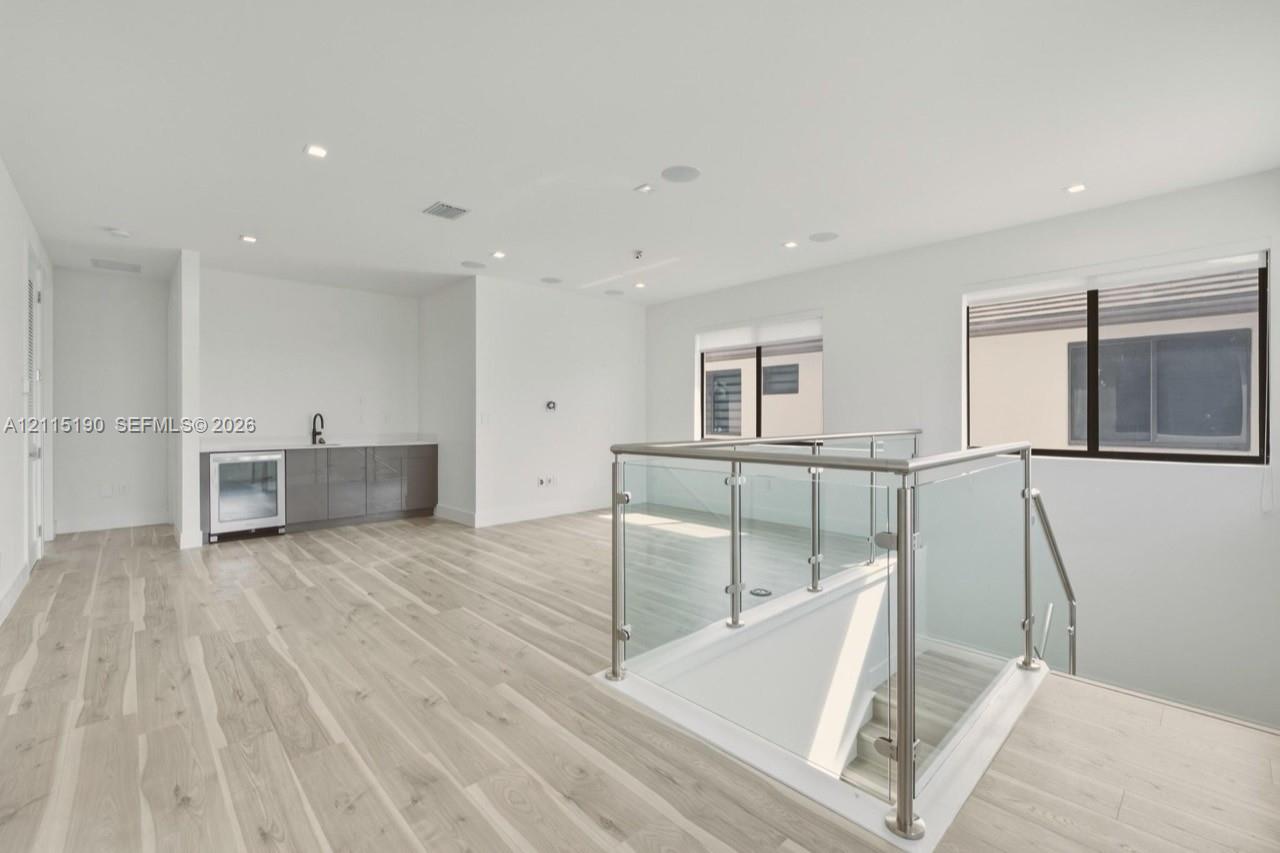Upstairs loft with wet bar and beverage refrigerator.