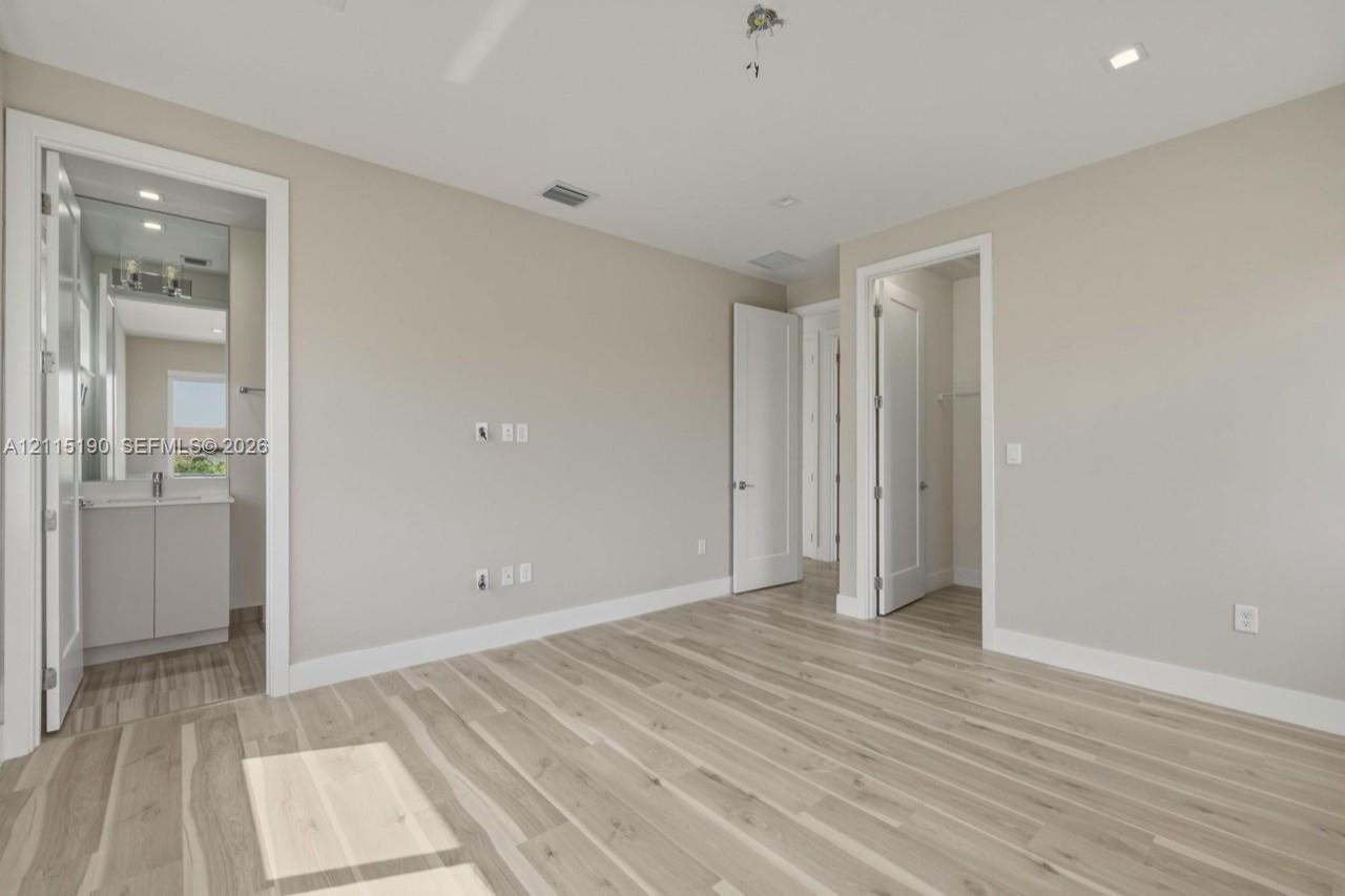 Bedroom with adjoining bathroom and closet.