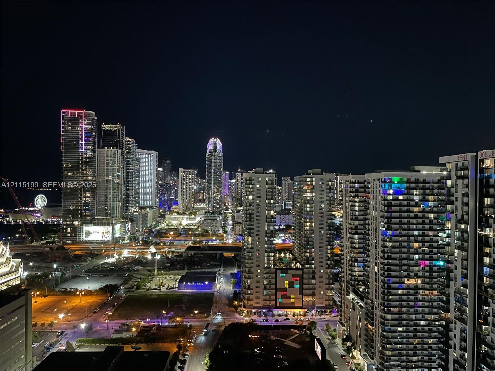 Panoramic urban skyline featuring high-rise architecture and illuminated cityscape