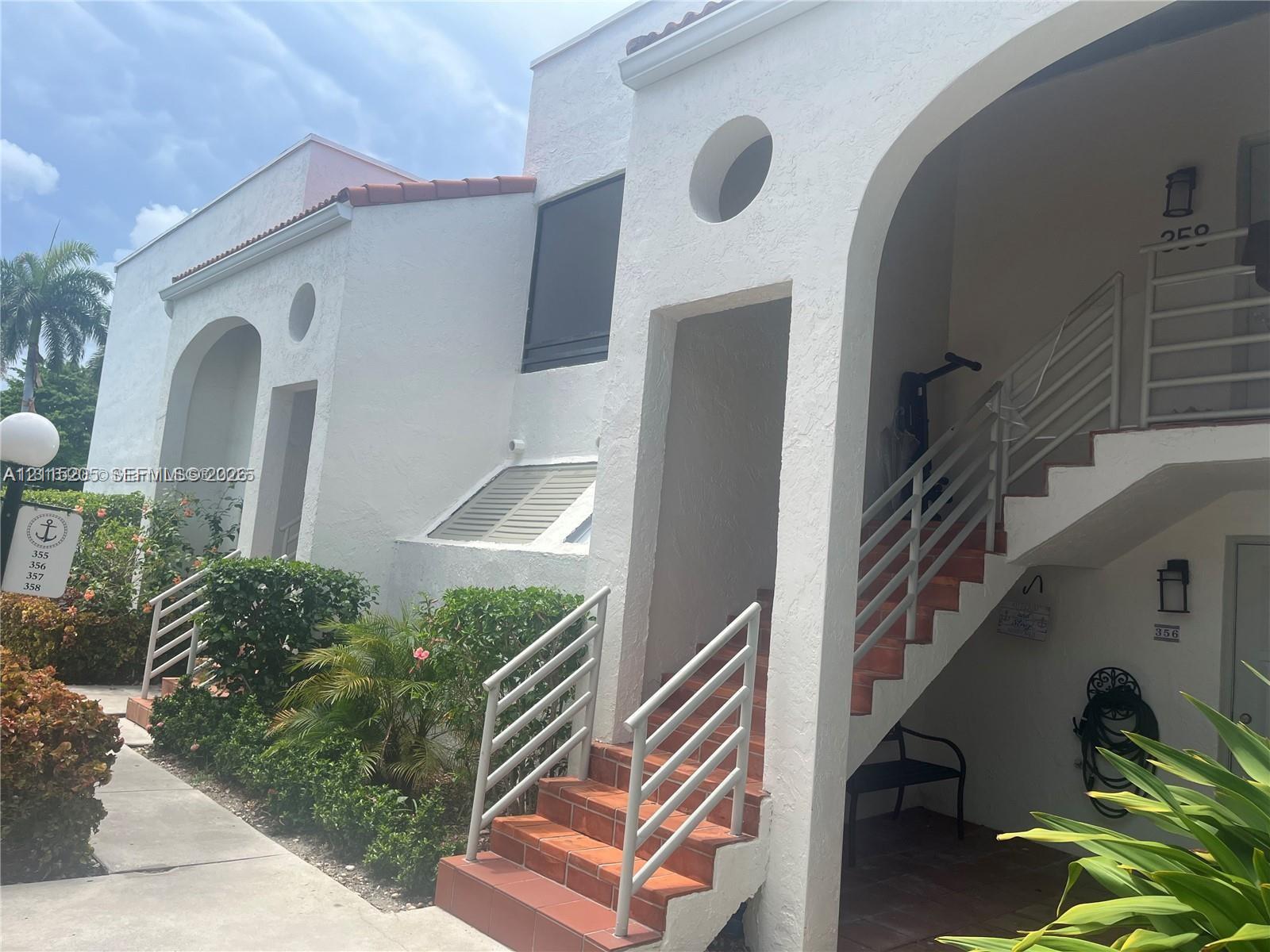 Stucco exterior featuring arched entryways, circular accent windows, terracotta-tile stairs. Stucco exterior featuring arched entryways, circular accent windows, terracotta-tile stairs.