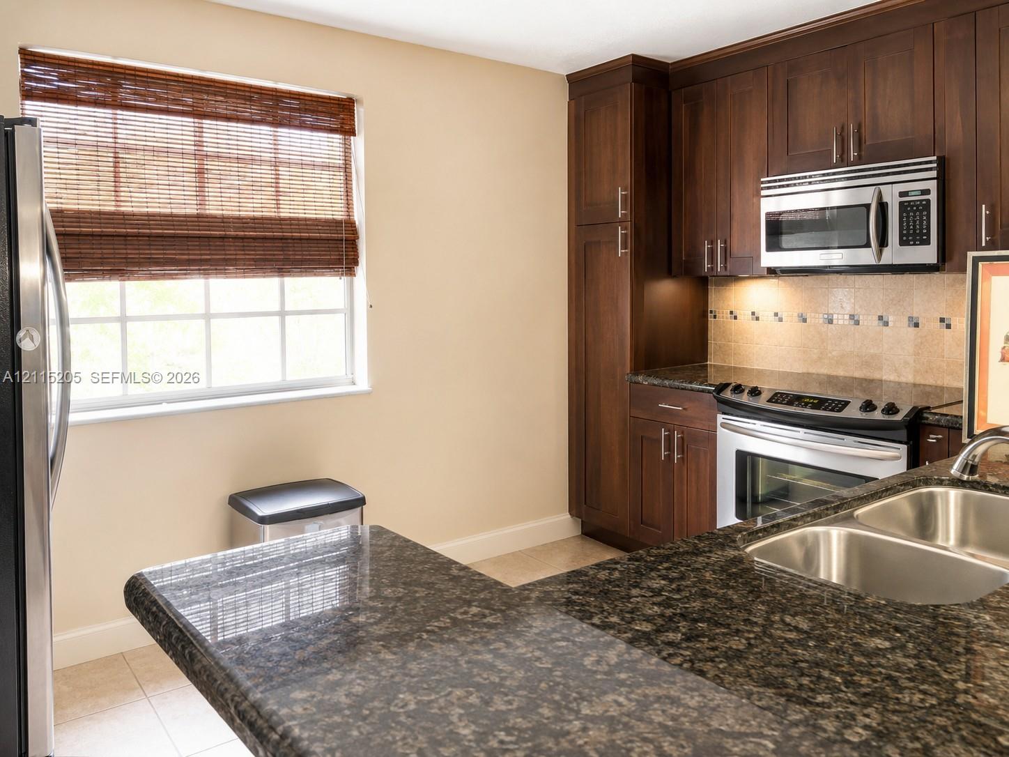 Kitchen featuring large picture window for natural light