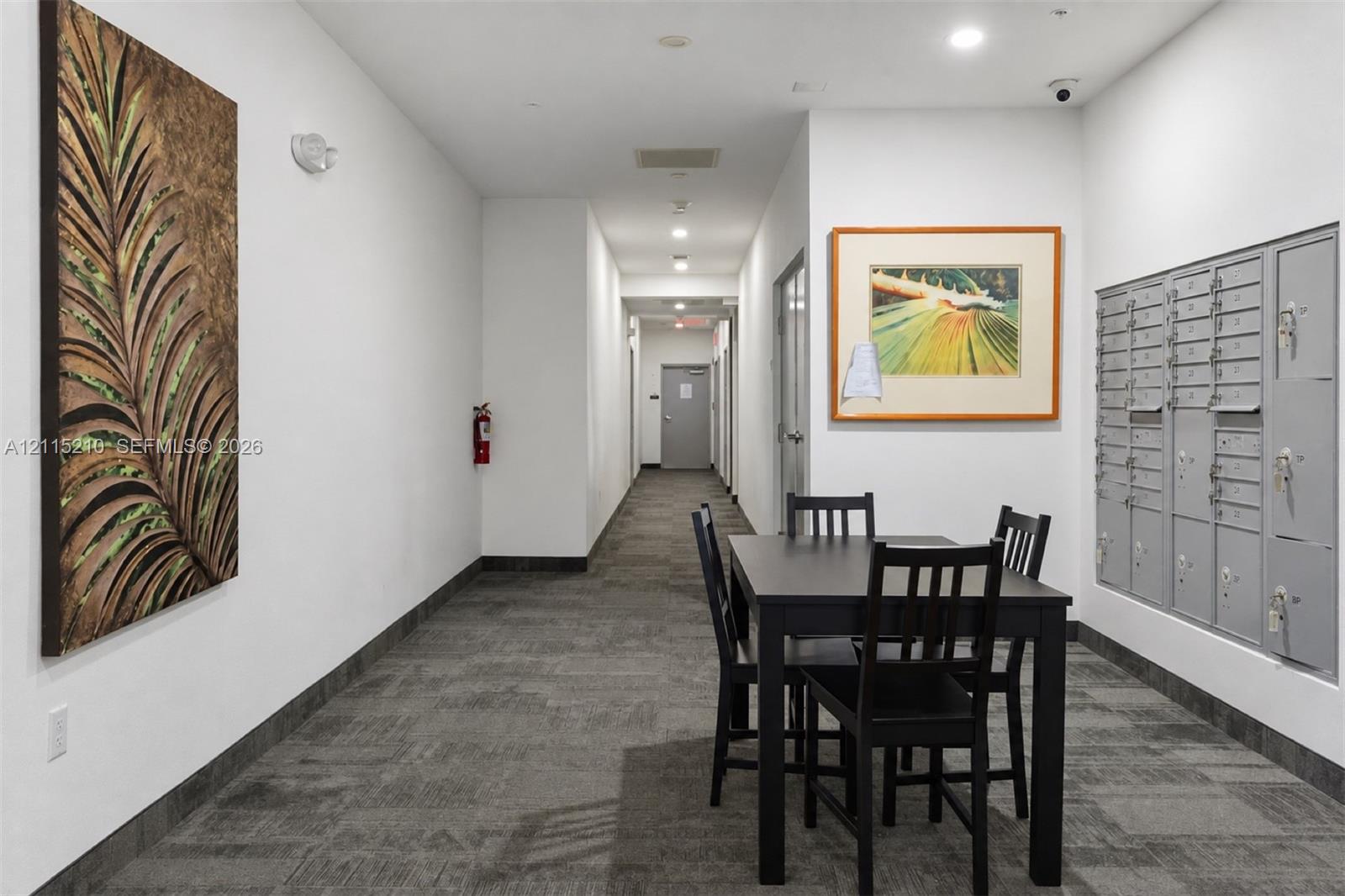 Common area featuring neutral-toned carpeting, recessed ceiling lighting, and built-in metal parcel lockers