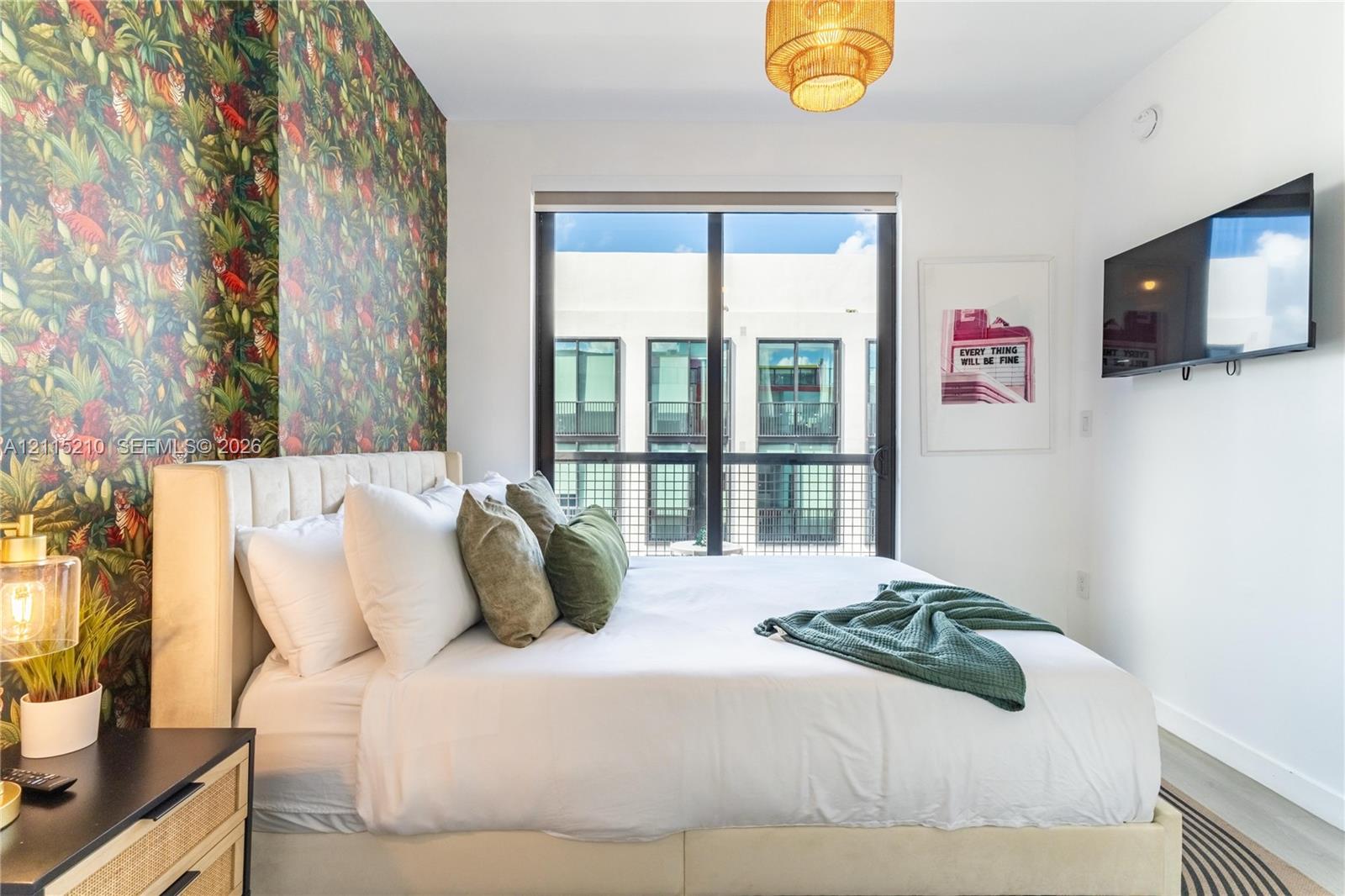 Floor-to-ceiling window with metal frame, patterned accent wall, and pendant lighting fixture