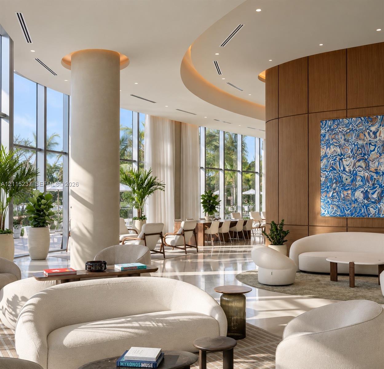 Floor-to-ceiling windows, curved architectural ceiling with recessed lighting, structural cylindrical column, and paneled wood-finish wall accents