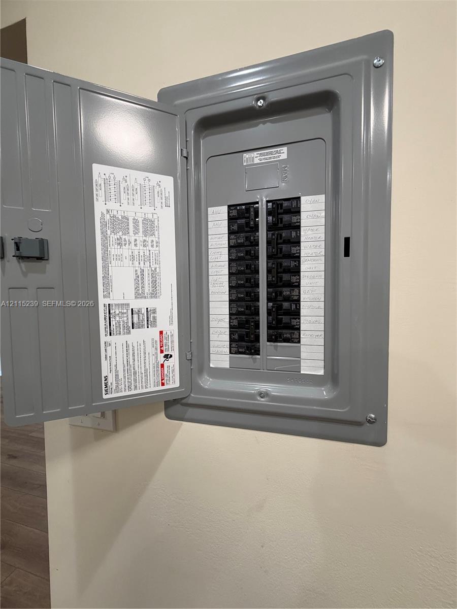 Siemens electrical service panel featuring a recessed metal enclosure, hinged door, and multiple circuit breakers