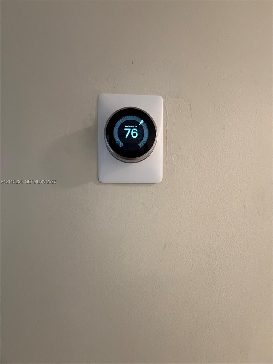 Wall-mounted digital smart thermostat featuring a circular display interface