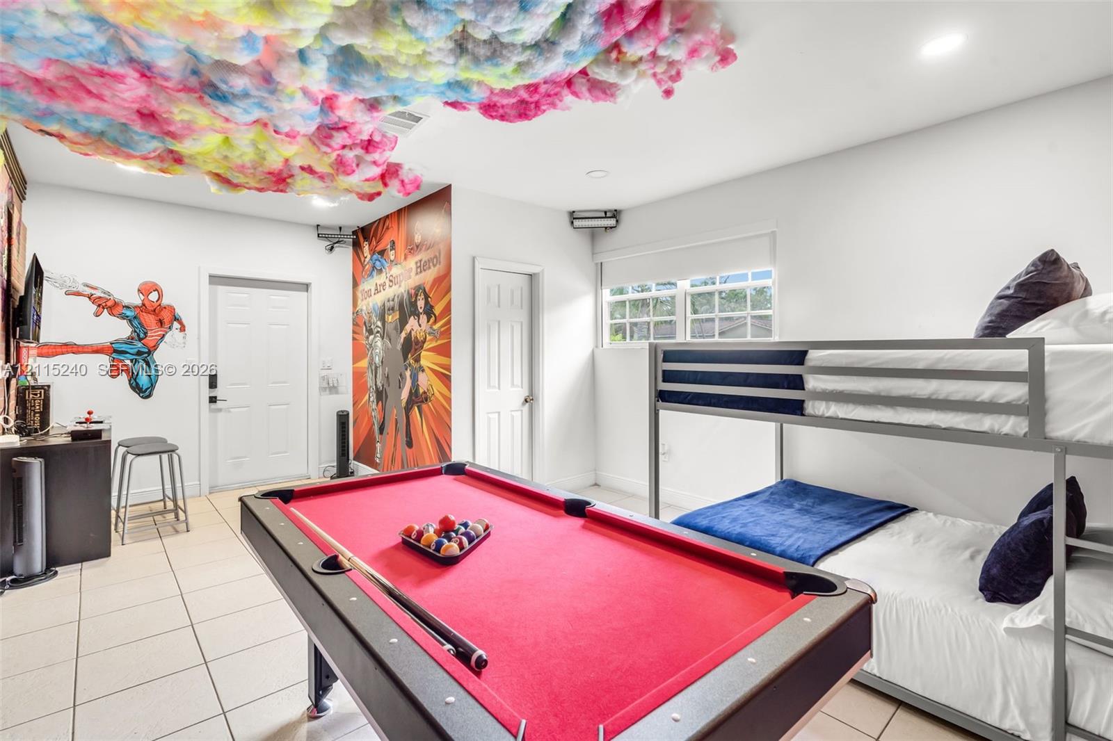 Spacious interior featuring light-toned tile flooring, recessed lighting, and white walls