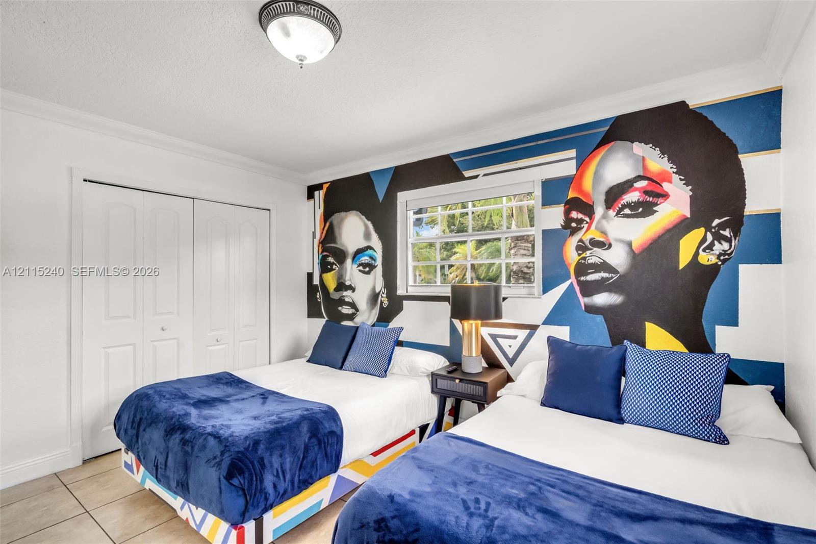Room featuring large-format ceramic tile flooring, double-door closet with paneled detailing, dual-pane window with muntins, and a semi-flush mount ceiling fixture