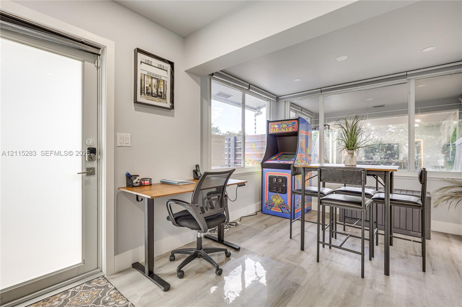 Full-light glass exterior door featuring a smart lock, light-tone wood-finish flooring, recessed ceiling lighting, and expansive floor-to-ceiling windows
