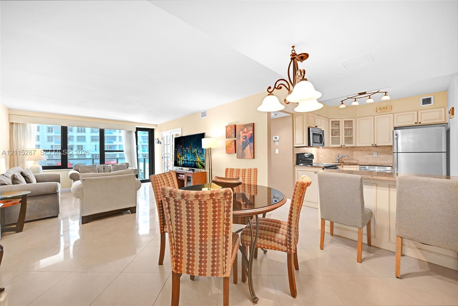 Open-concept interior featuring large-format tile flooring, recessed lighting, and expansive windows