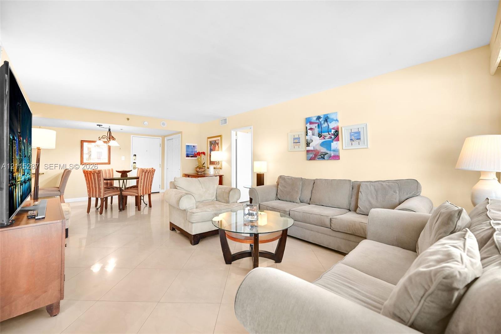 Open-concept interior featuring large-format tile flooring and recessed lighting