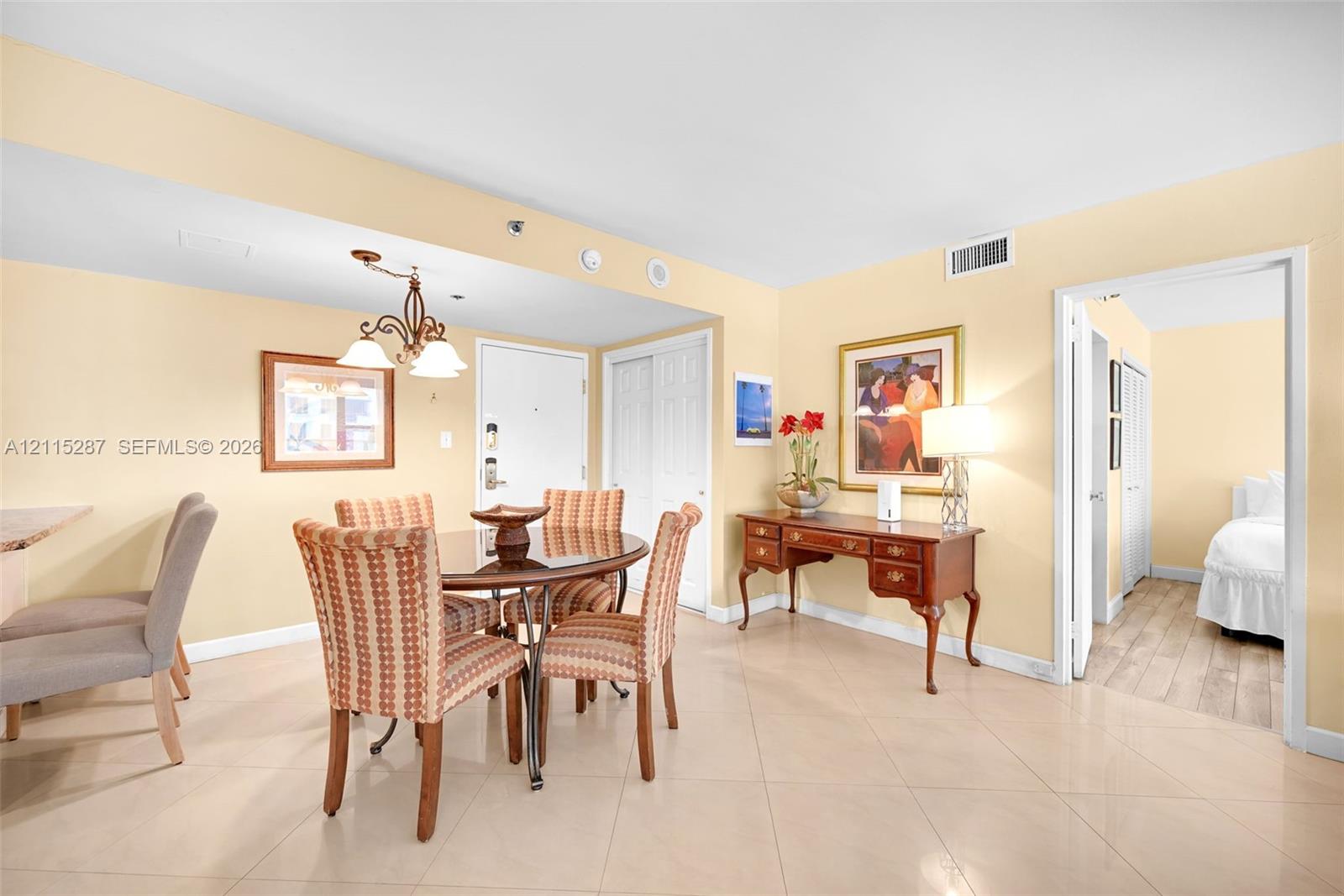 Light-toned ceramic tile flooring, neutral wall palette, and white multi-panel interior doors