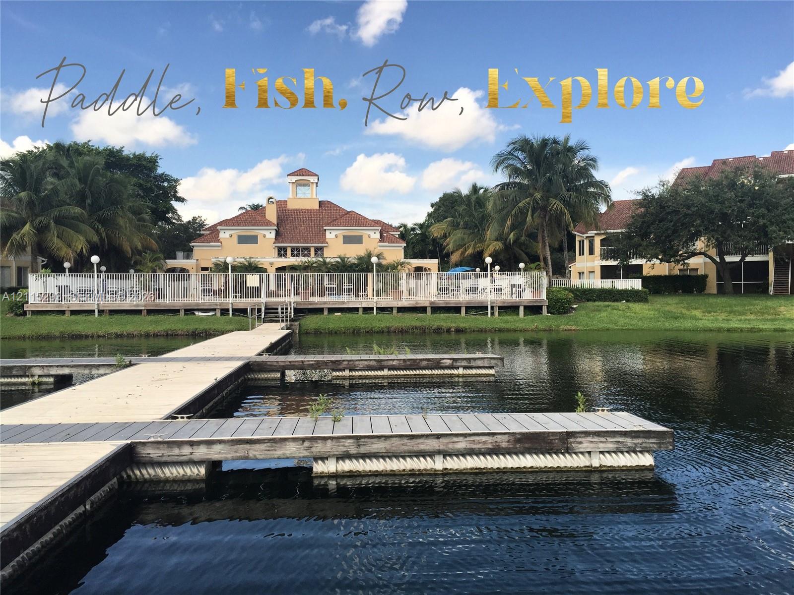 Private waterfront dock with direct water access, multi-level building with tiled roof, and established landscaping