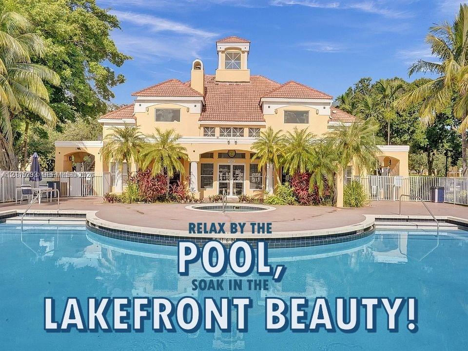 Stucco exterior featuring a tiled hip roof, architectural cupola, covered veranda, and a concrete deck surrounding an in-ground swimming pool
