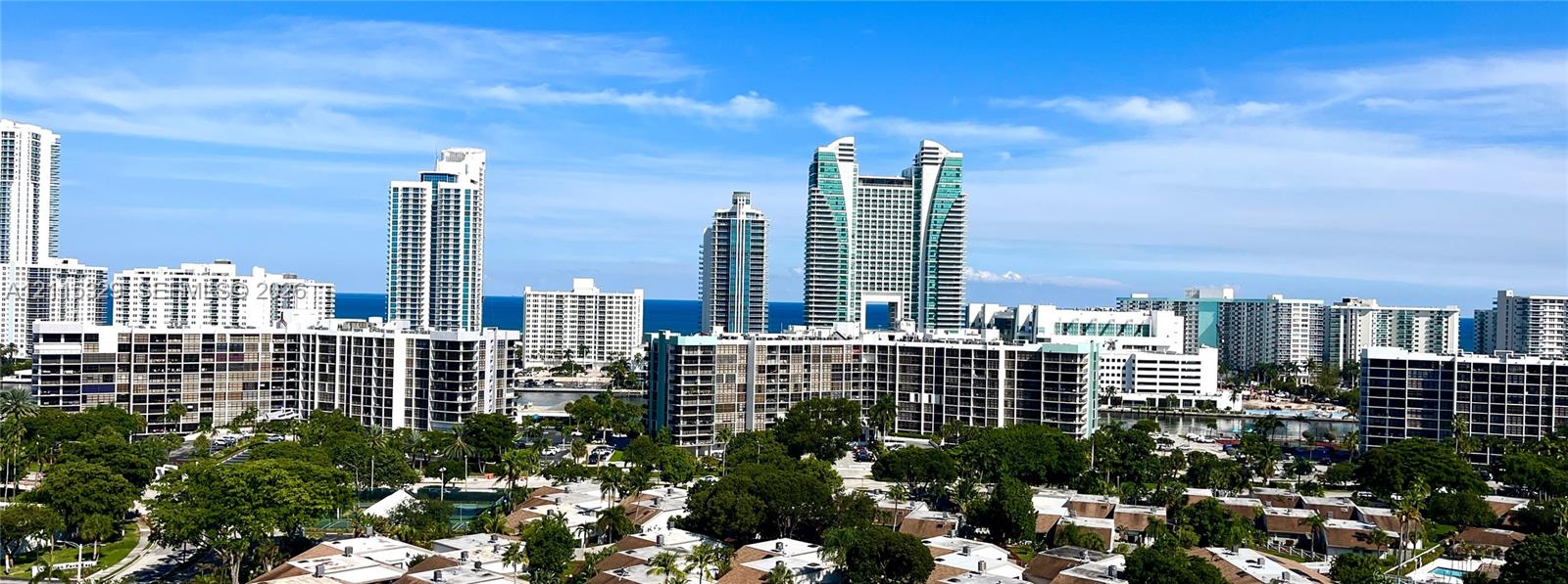Panoramic cityscape featuring high-rise architecture and expansive water frontage