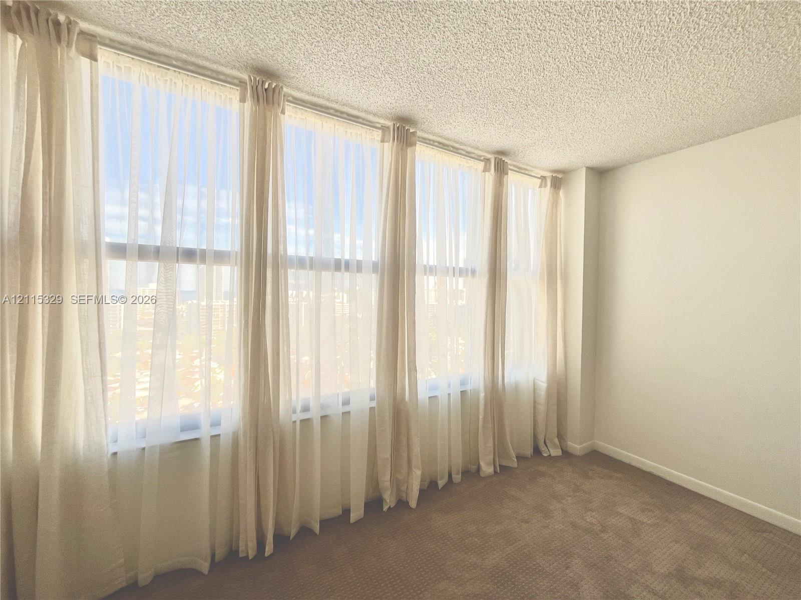 Expansive floor-to-ceiling windows featuring natur