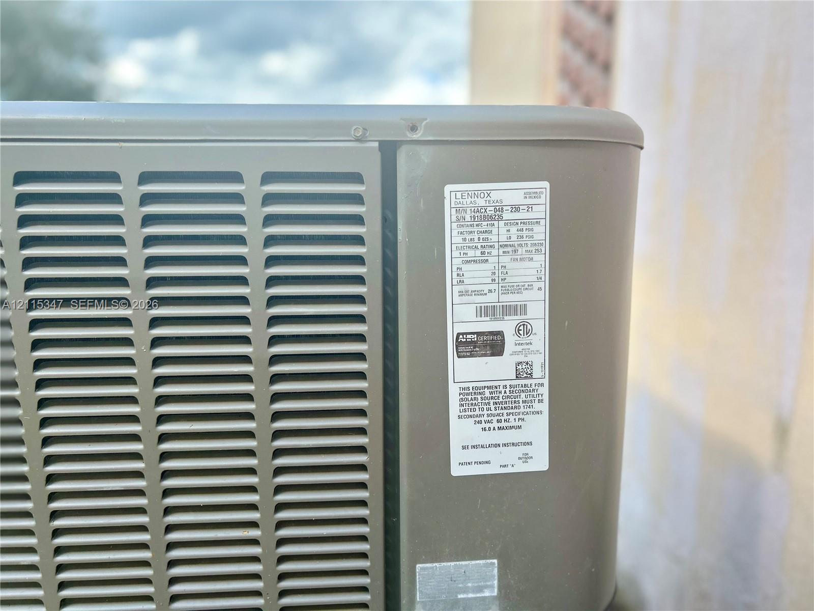 Lennox air conditioning unit featuring an exterior-grade metallic housing, industrial ventilation grilles, and a standardized equipment identification panel