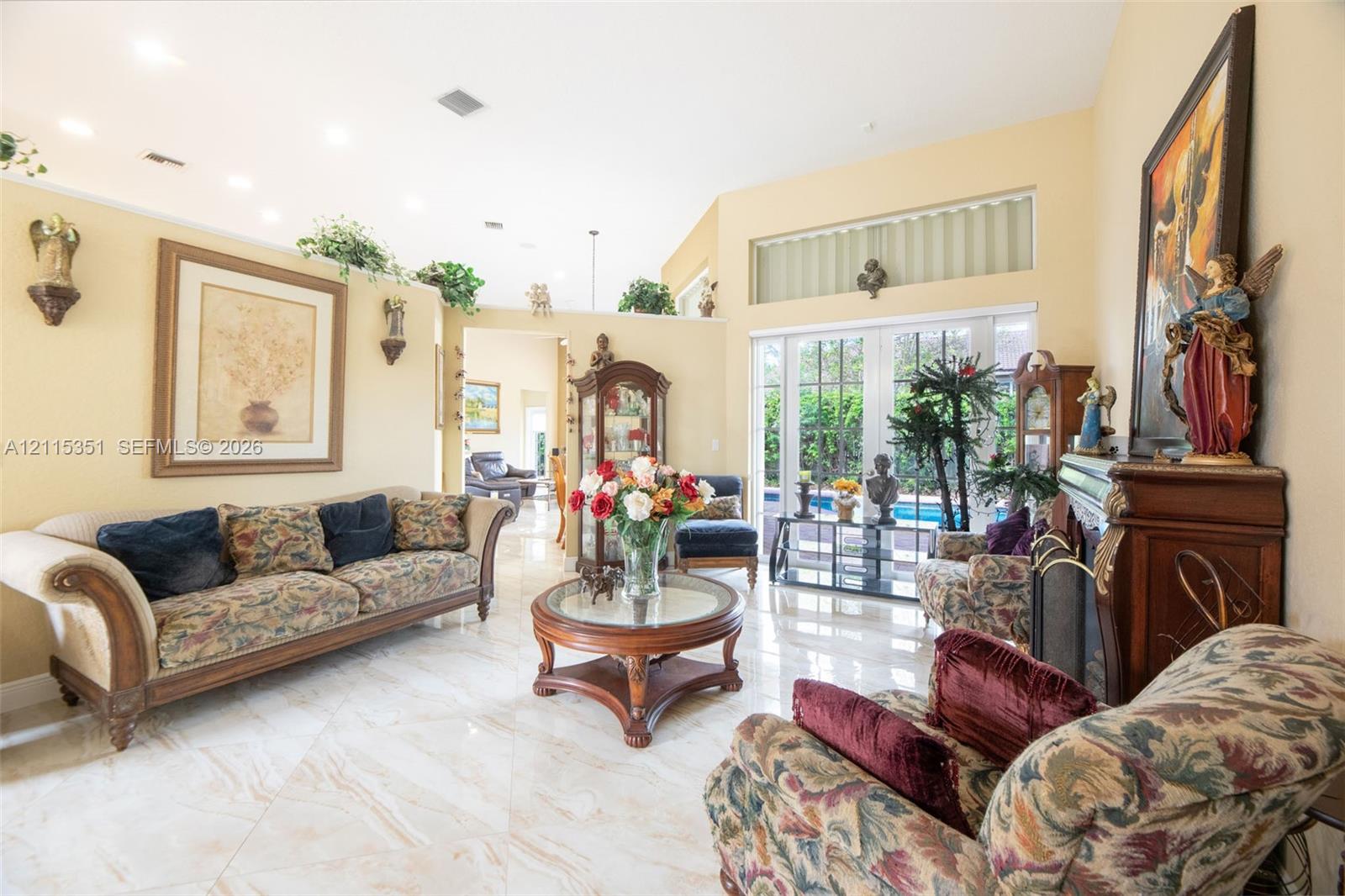 Vaulted ceilings, polished tile flooring, recessed lighting, fireplace with a carved mantle, and sliding glass doors Vaulted ceilings, polished tile flooring, recessed lighting, fireplace with a carved mantle, and sliding glass doors