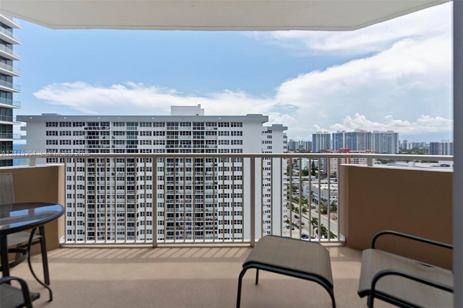 Covered balcony with a solid perimeter wall and a metal railing
