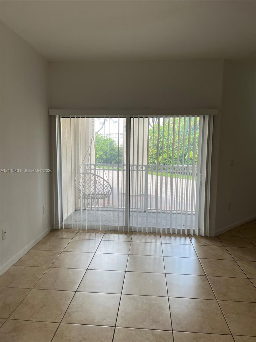Ceramic tile flooring and sliding glass doors providing outdoor access