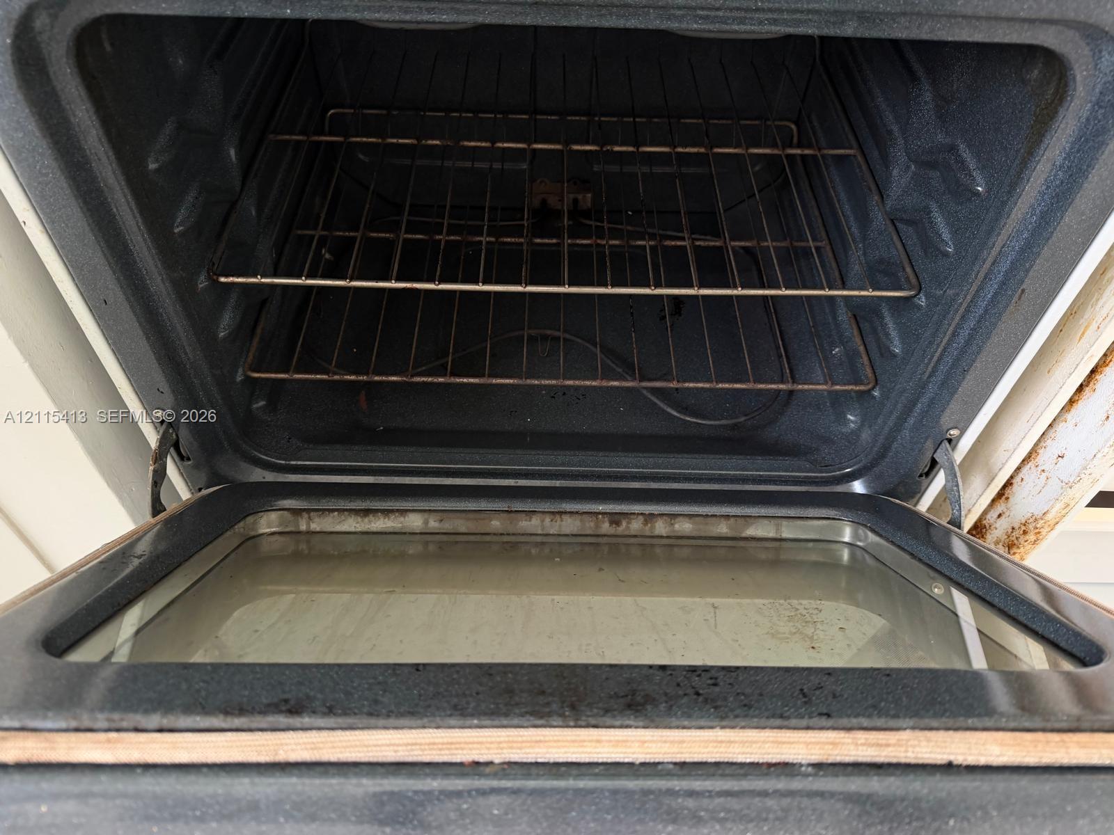 Built-in wall oven featuring an integrated glass-paneled door and interior wire shelving racks