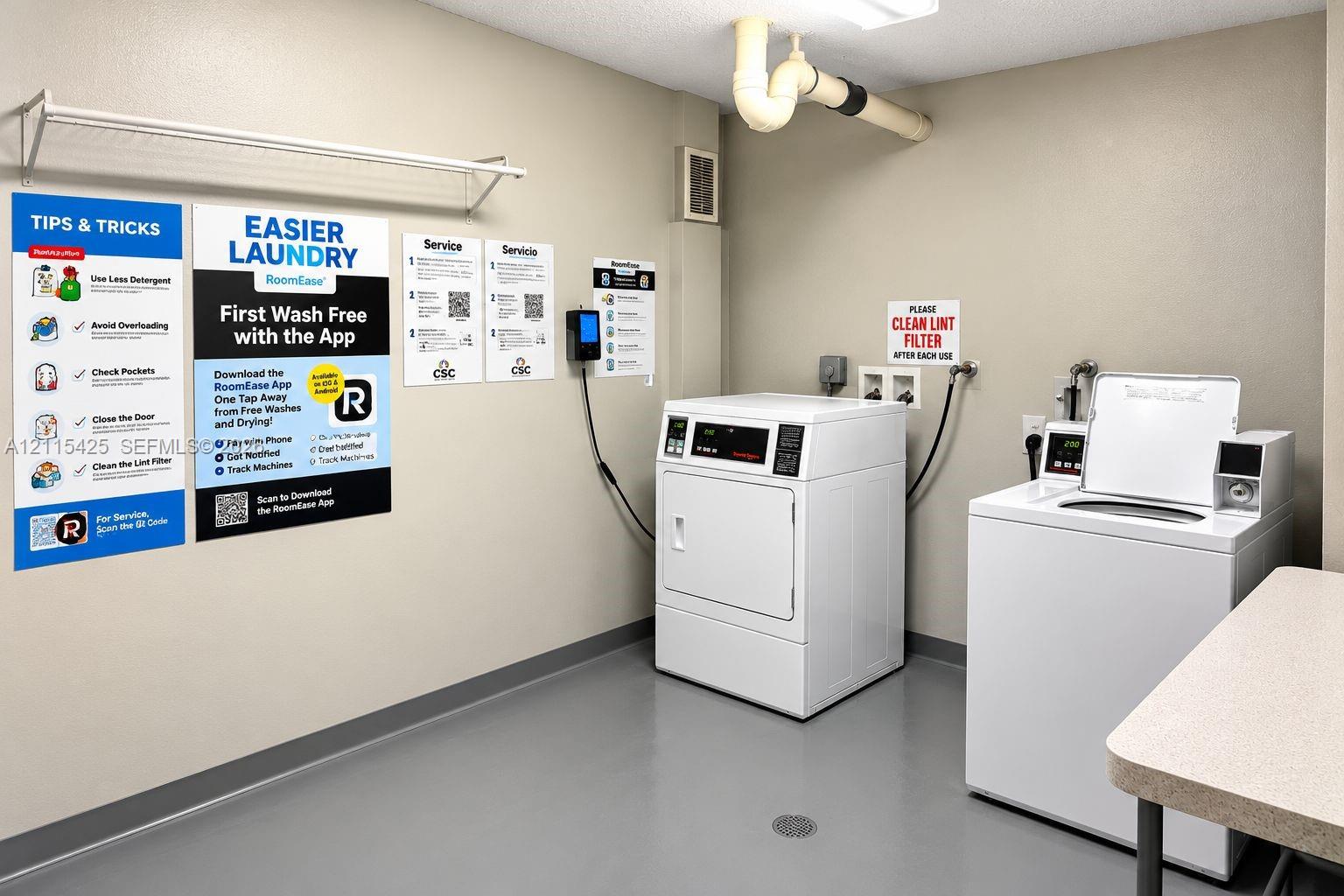Laundry area featuring industrial-grade washers and dryers, a metal wall-mounted drying rack, and durable flooring