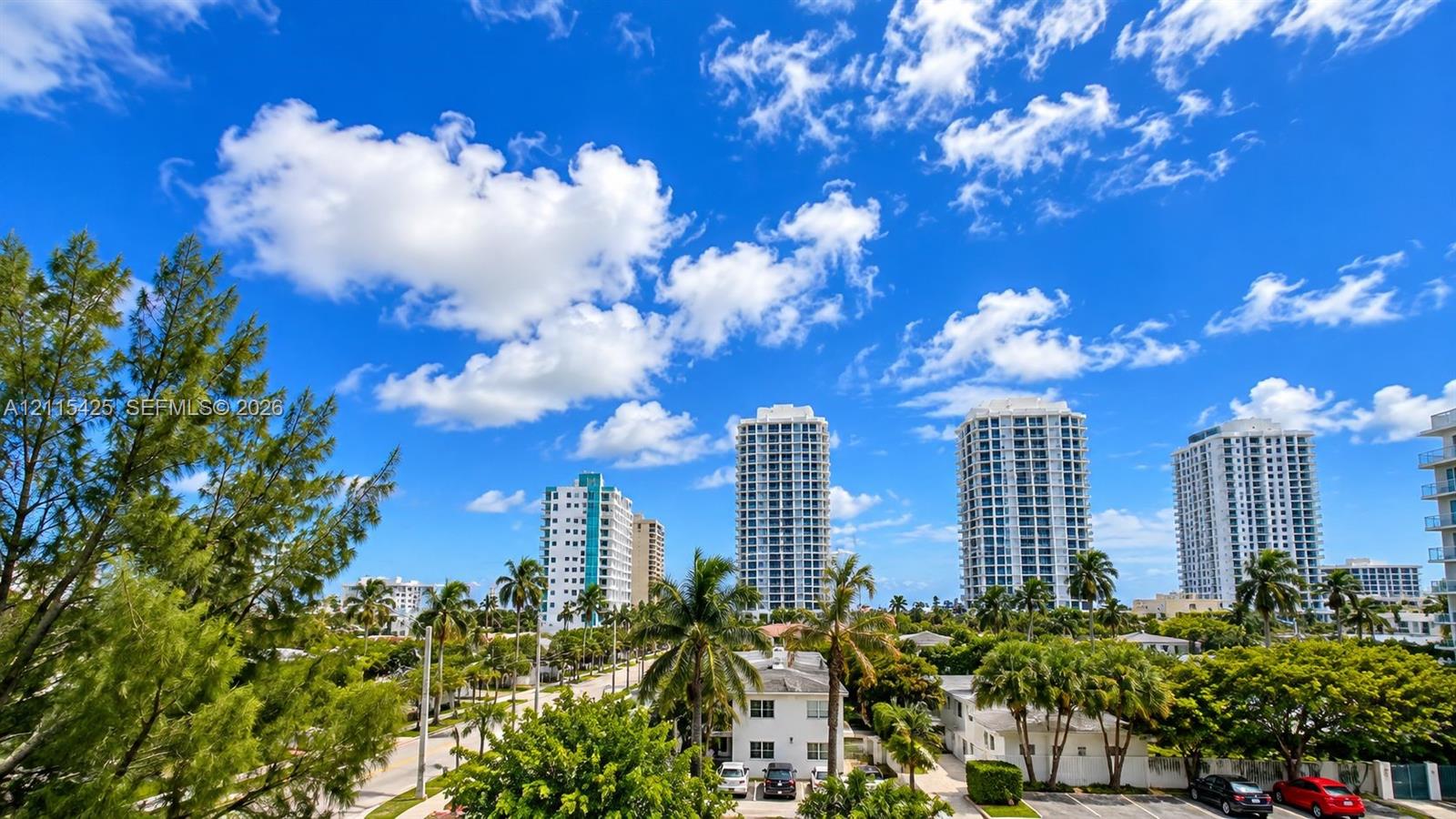 High-rise urban landscape featuring mature tropical vegetation, paved streets, and multi-story residential architecture
