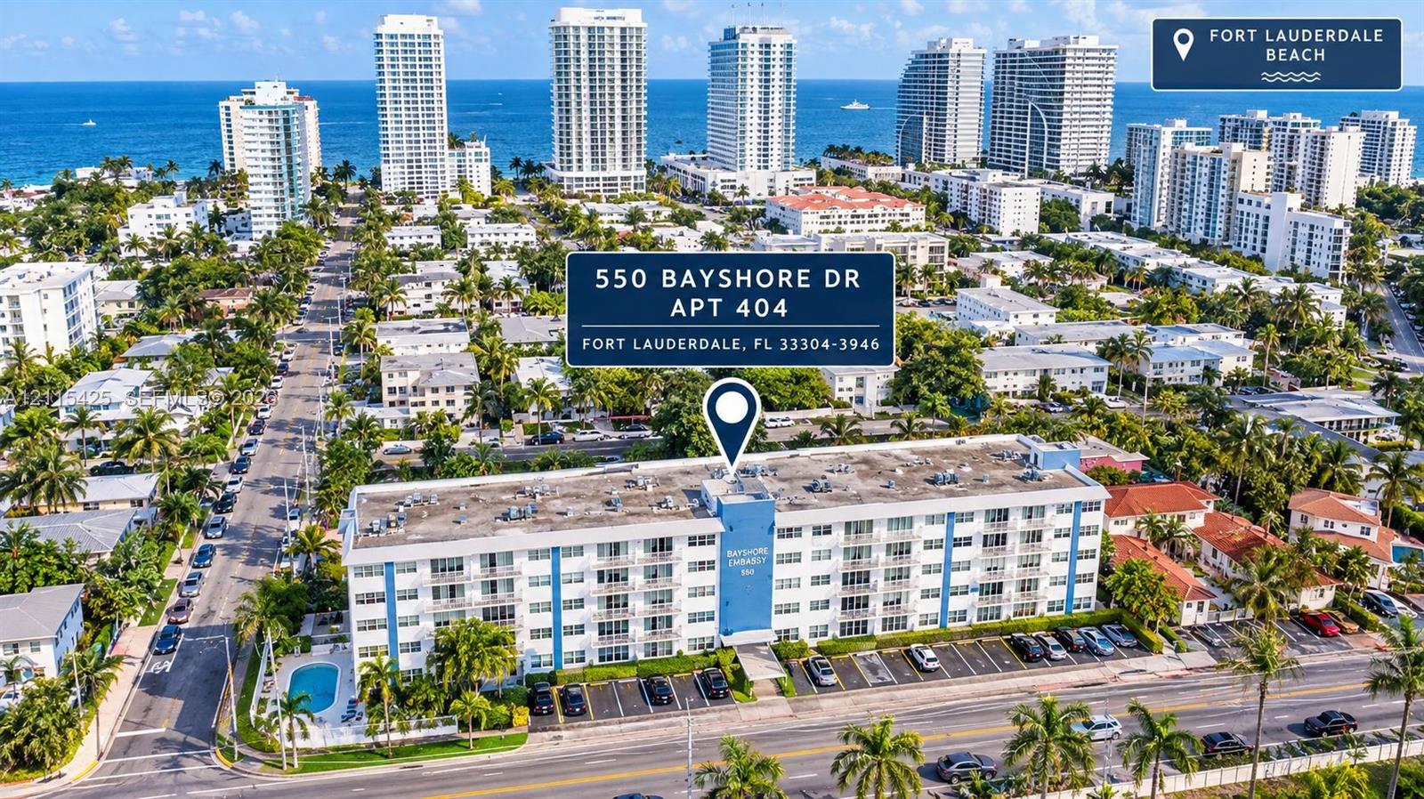 Aerial perspective of multi-story residential building featuring exterior balconies, an outdoor swimming pool, and dedicated surface parking Aerial perspective of multi-story residential building featuring exterior balconies, an outdoor swimming pool, and dedicated surface parking