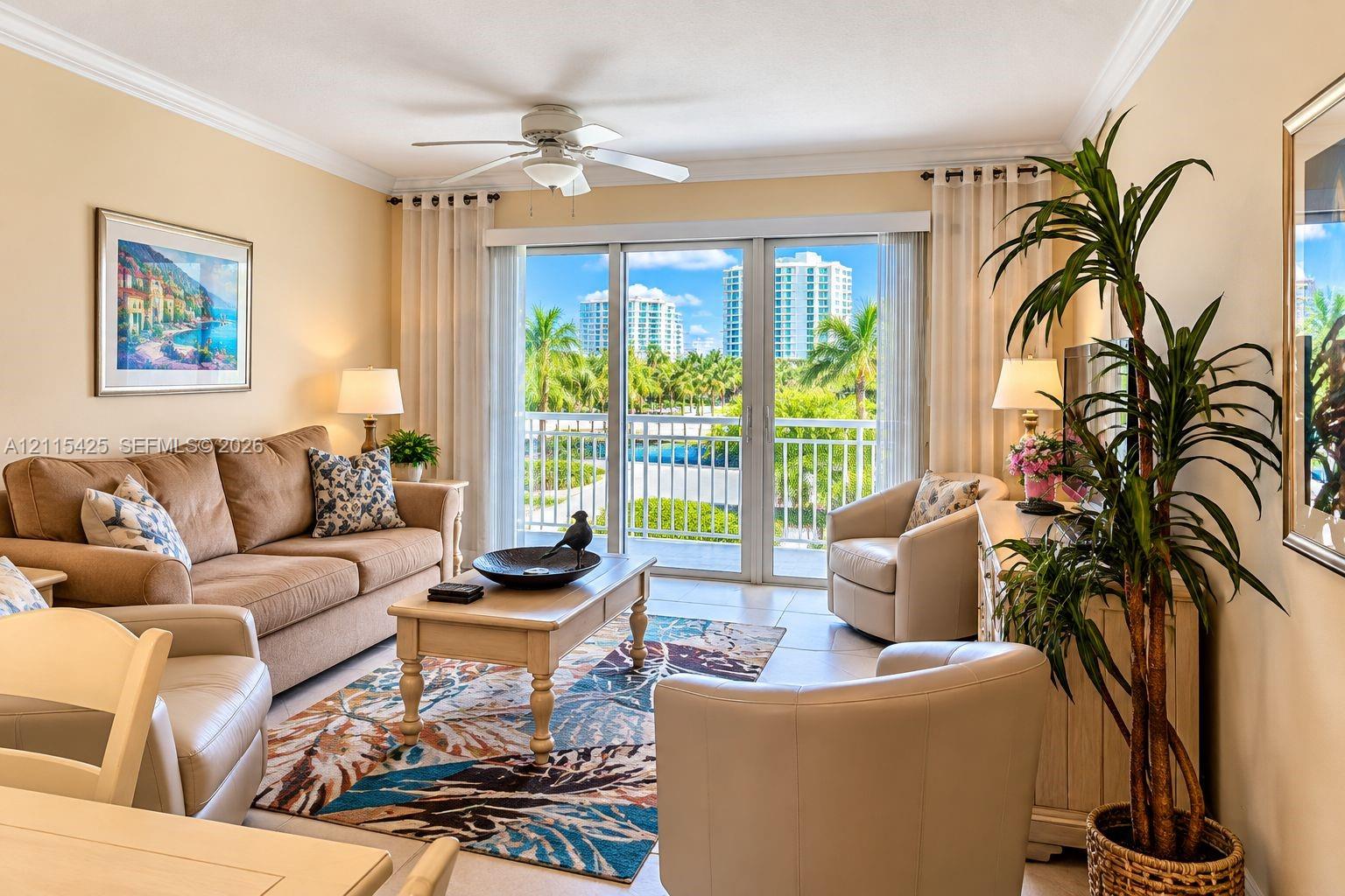 Living area featuring tile flooring, crown molding, a ceiling fan, and floor-to-ceiling sliding glass doors opening to a private balcony