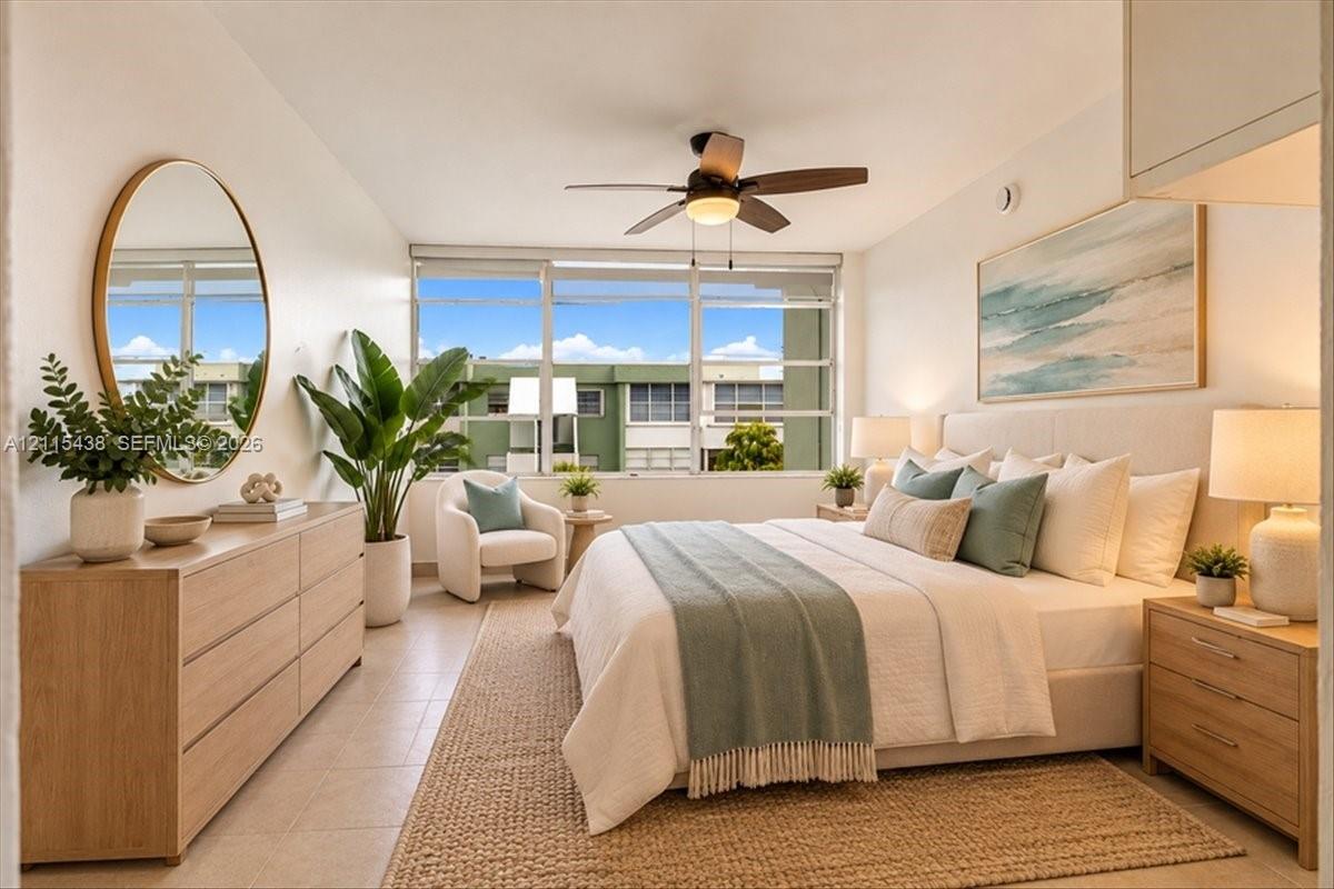 Expansive multi-pane window, ceiling fan with integrated lighting, neutral tile flooring, and smooth-finish walls