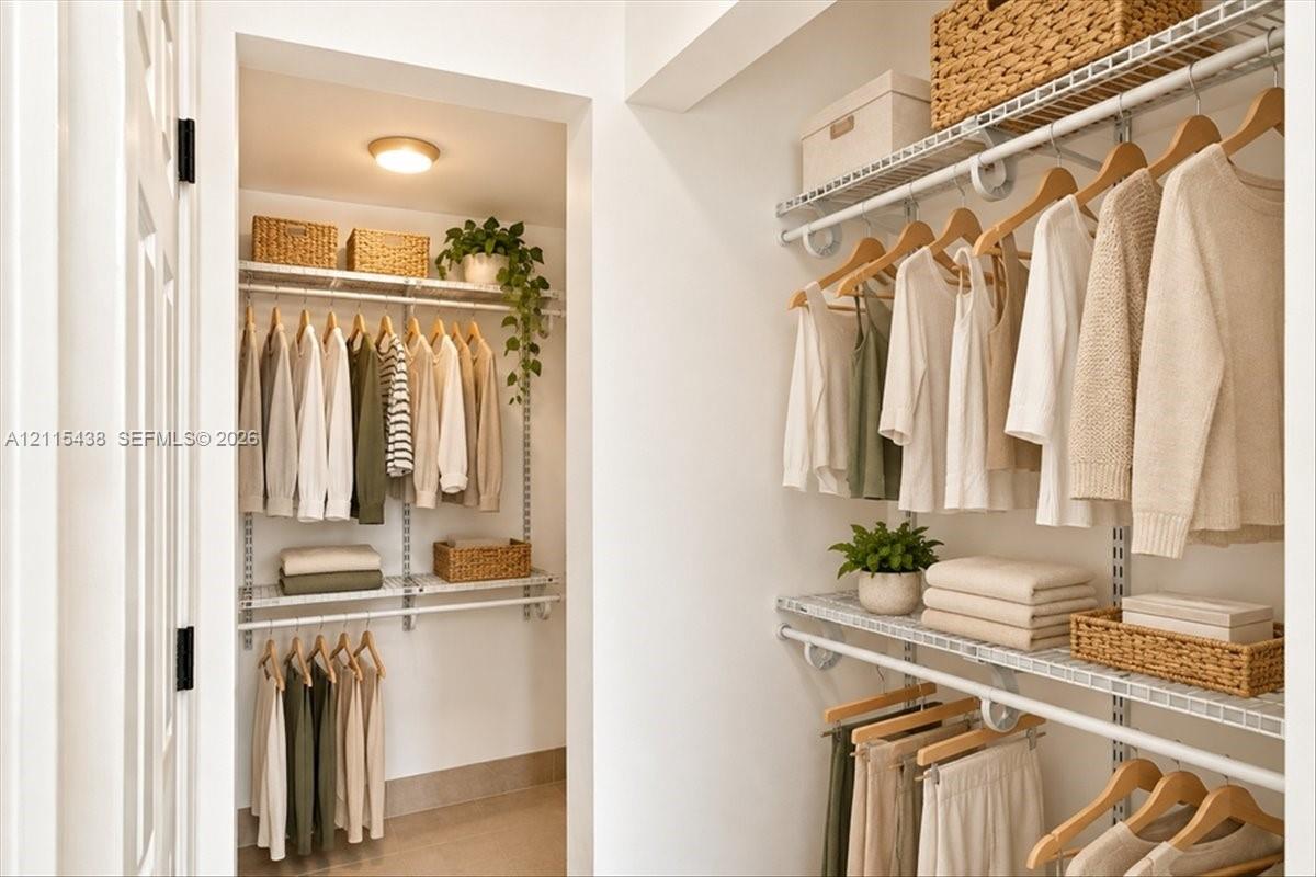 Walk-in closet featuring tiered wire shelving, mounted closet rods, and overhead flush-mount lighting