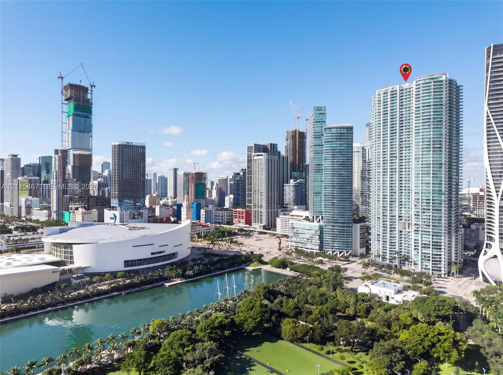 High-rise residential tower located within a metropolitan urban district featuring expansive glass-facade architecture, proximity to waterfront green space, and regional stadium infrastructure