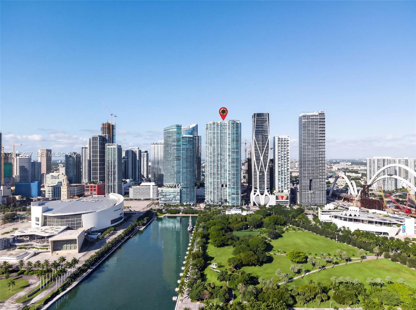 Aerial perspective of high-rise residential tower located within a metropolitan urban district