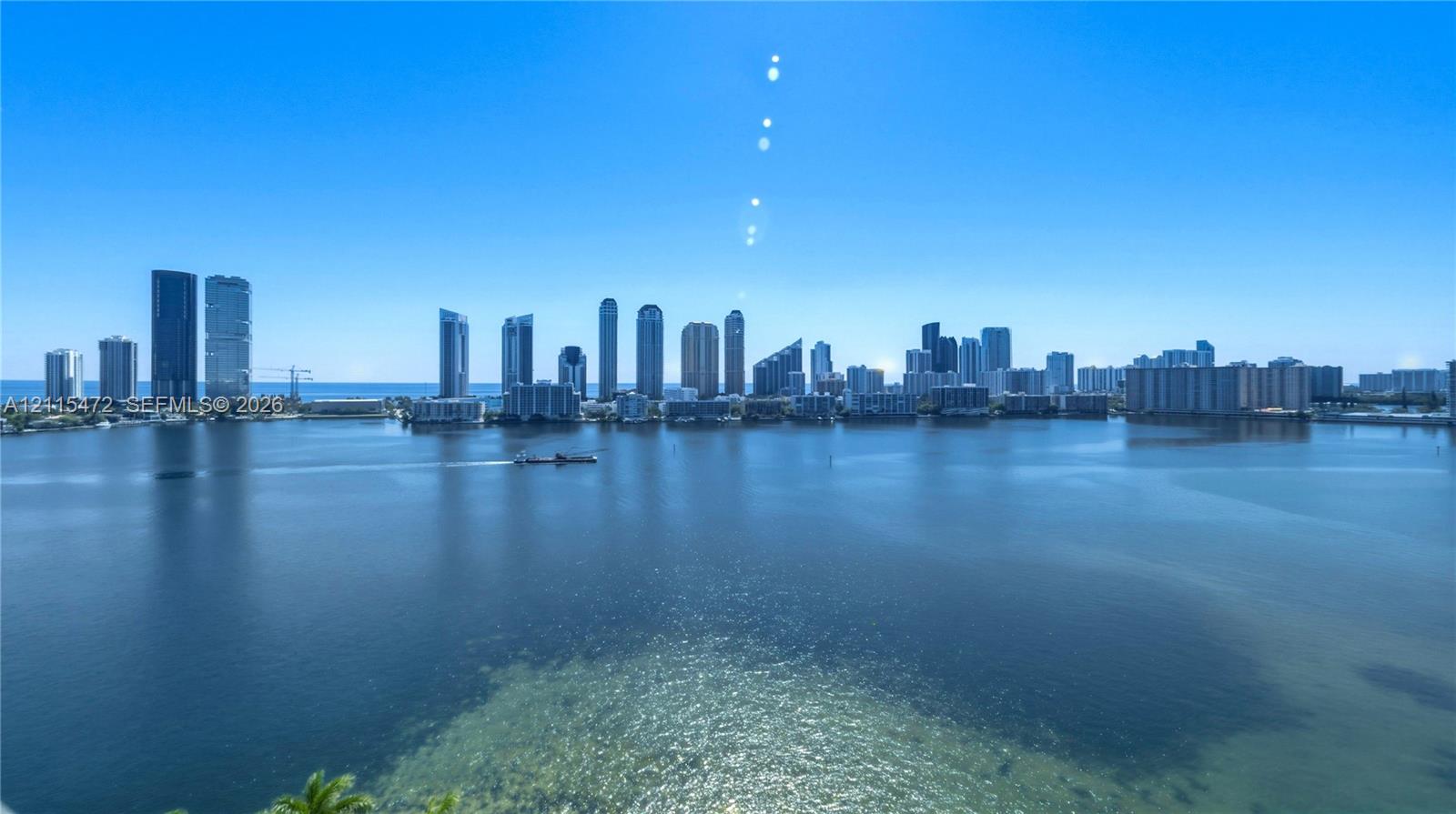 Panoramic coastal scenery featuring expansive water expanse and distant skyline