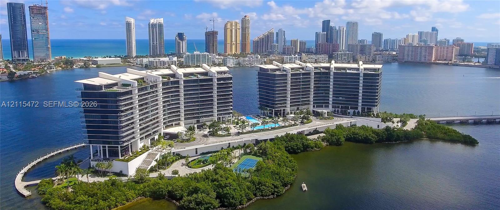 Waterfront high-rise property featuring private swimming pools, a tennis court, manicured landscaping, and direct water access