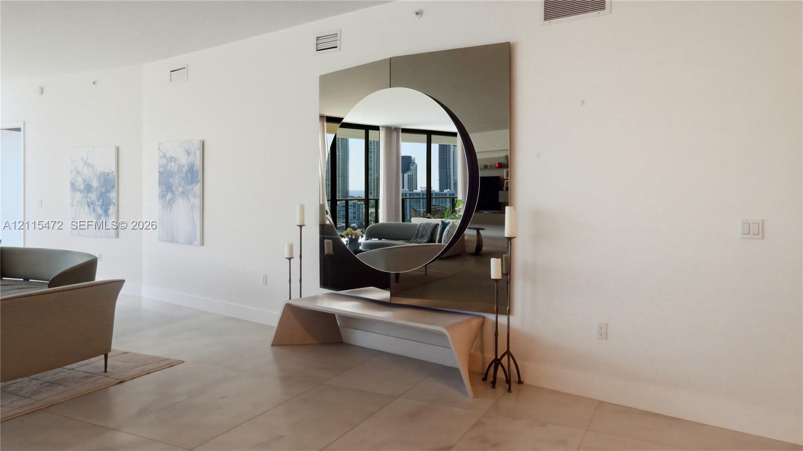Large-format square wall mirror with a circular cutout and smooth-finish porcelain floor tiling