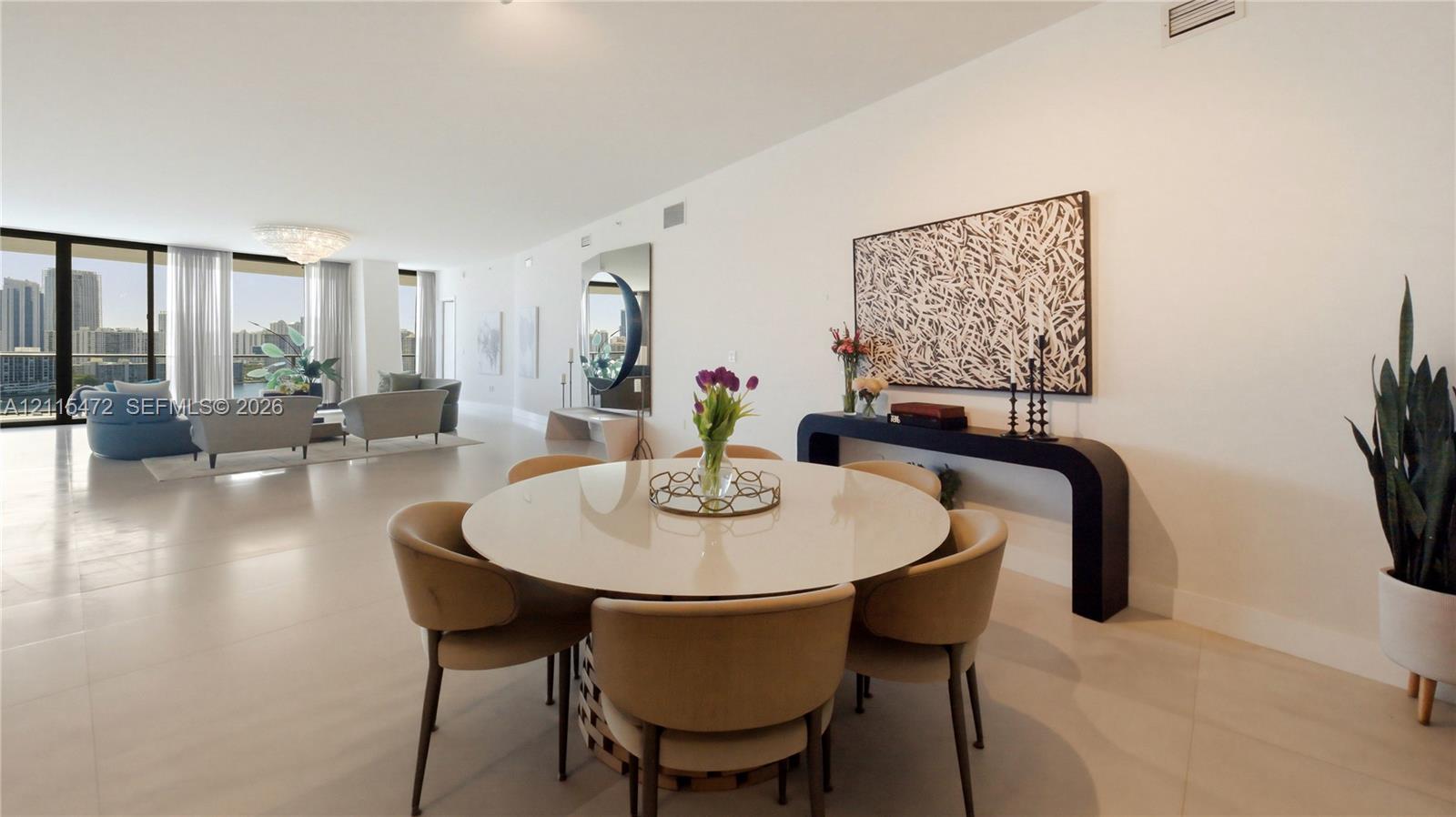 Open-concept floor plan featuring large-format tile flooring, floor-to-ceiling glass sliding doors, and neutral wall tones