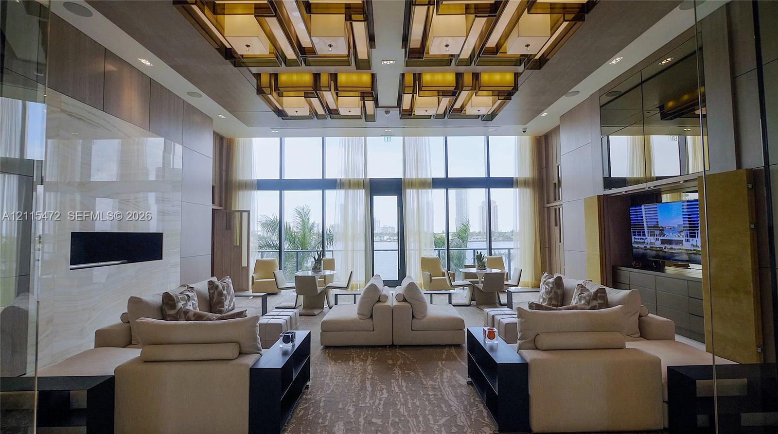 Double-height floor-to-ceiling windows, custom geometric recessed ceiling lighting, linear wall-integrated fireplace with stone-finish surround, and built-in cabinetry