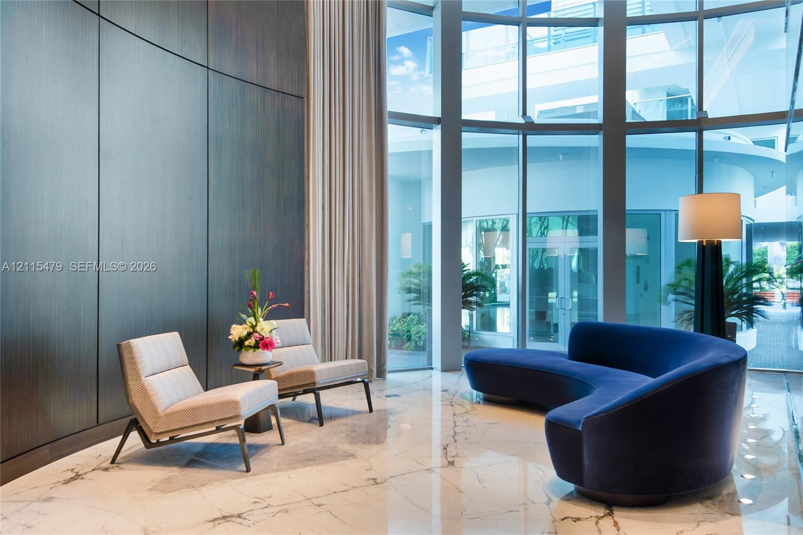 Floor-to-ceiling glass curtain wall, large-format polished stone flooring, and full-height dark wood paneling