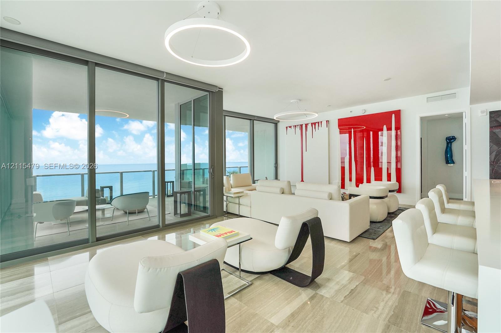 Floor-to-ceiling glass walls, polished stone flooring, circular LED light fixtures, and expansive private terrace Floor-to-ceiling glass walls, polished stone flooring, circular LED light fixtures, and expansive private terrace