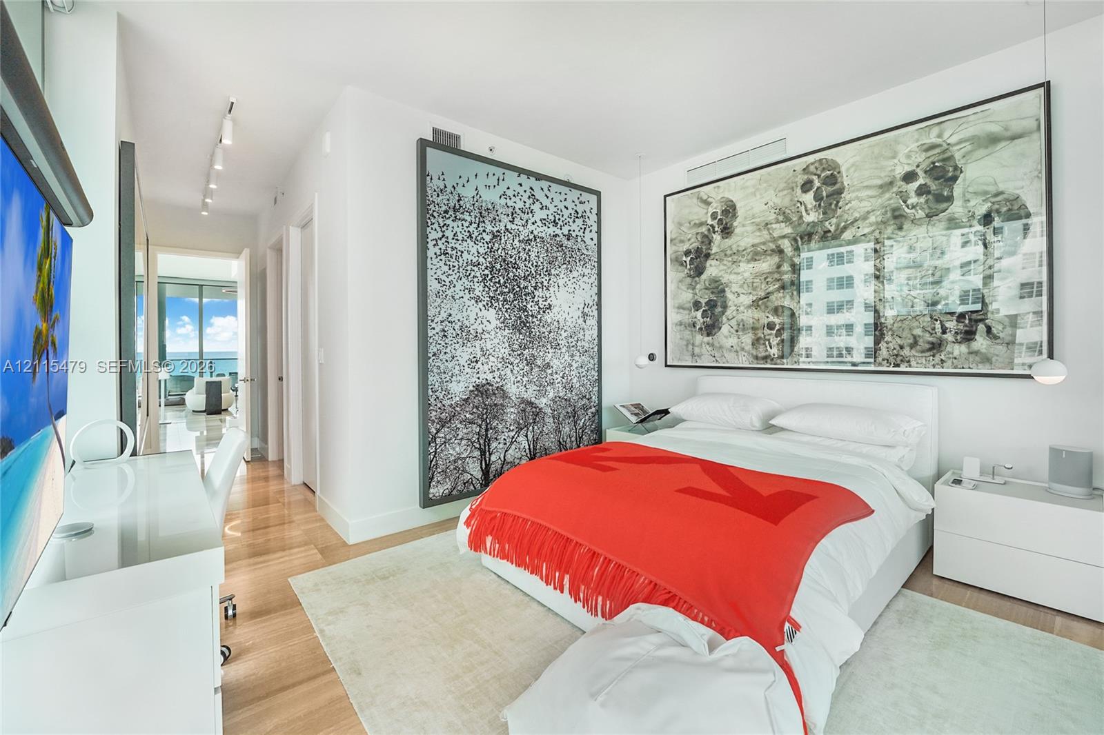 Wood-finish flooring, recessed track lighting, and floor-to-ceiling glass paneling