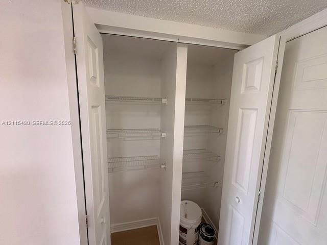 Storage closet featuring double-panel doors and integrated white wire shelving