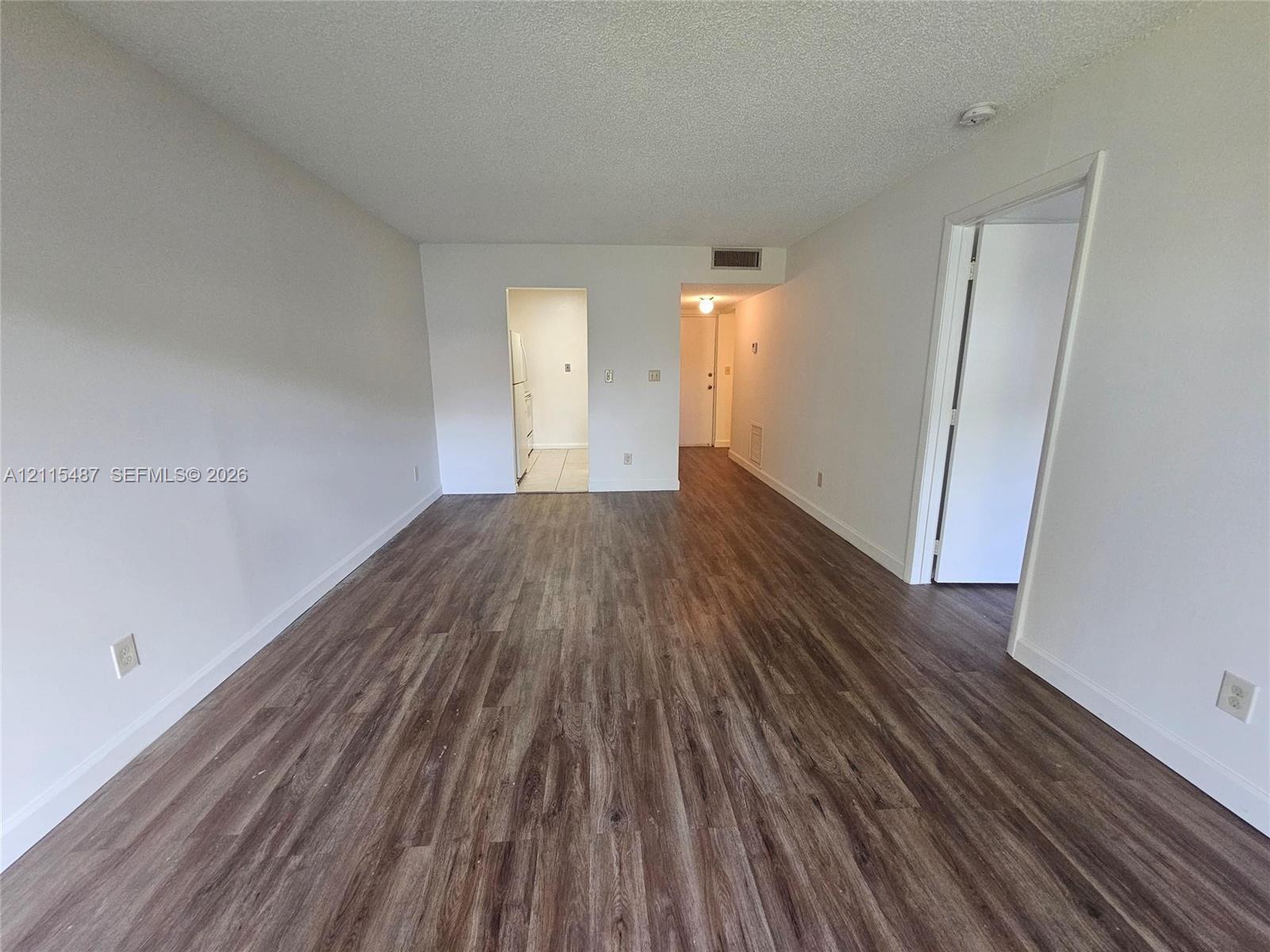 Interior area featuring wood-finish flooring and neutral-toned wall paint