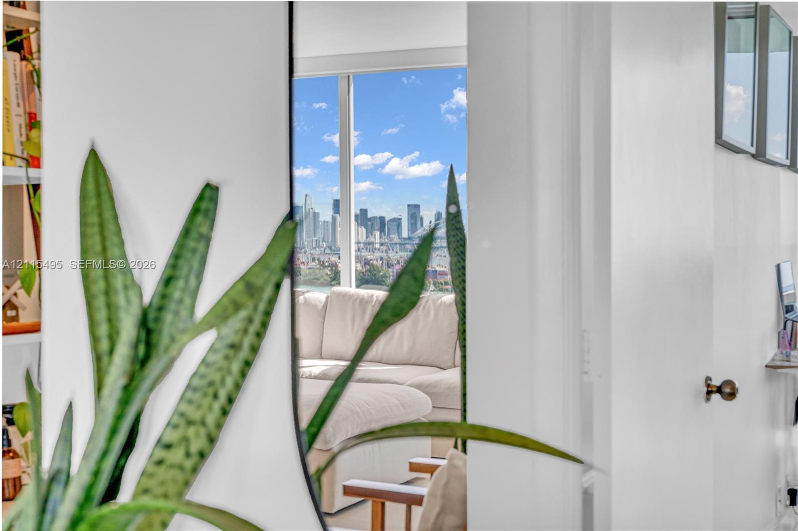 Floor-to-ceiling windows featuring urban skyline scenery and built-in shelving