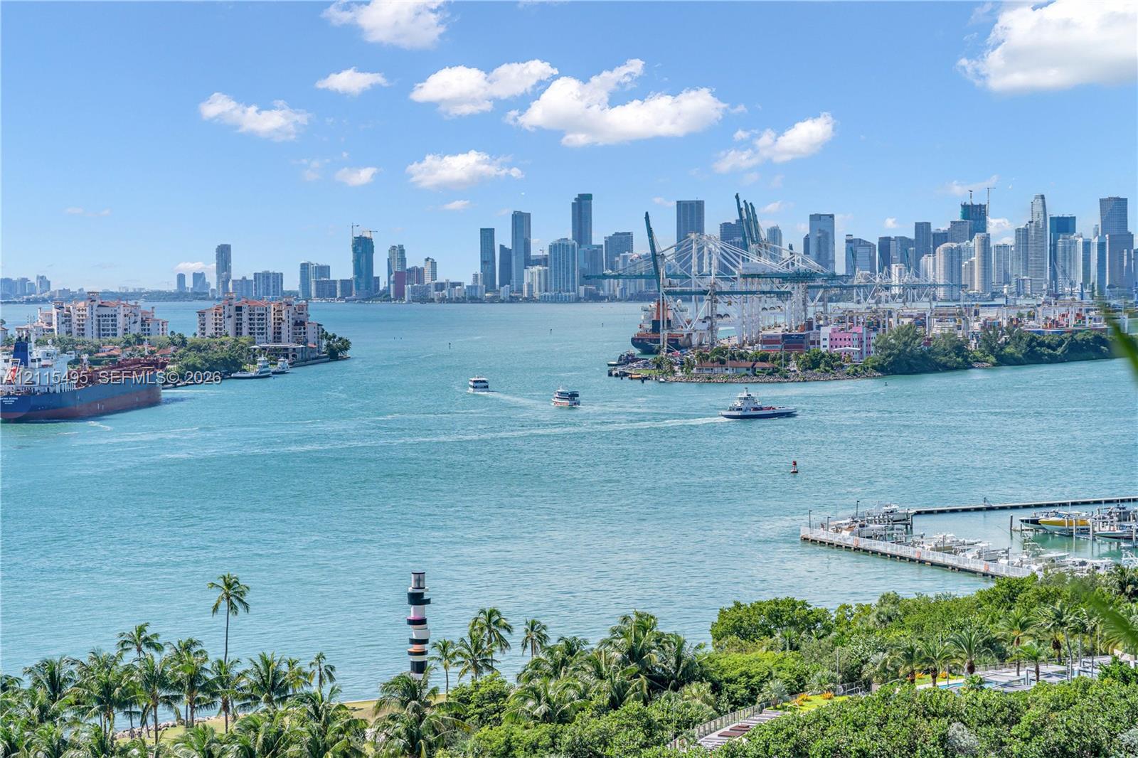 Panoramic water frontage featuring a skyline backdrop, coastal lighthouse, maritime waterway, and tropical palm tree landscaping
