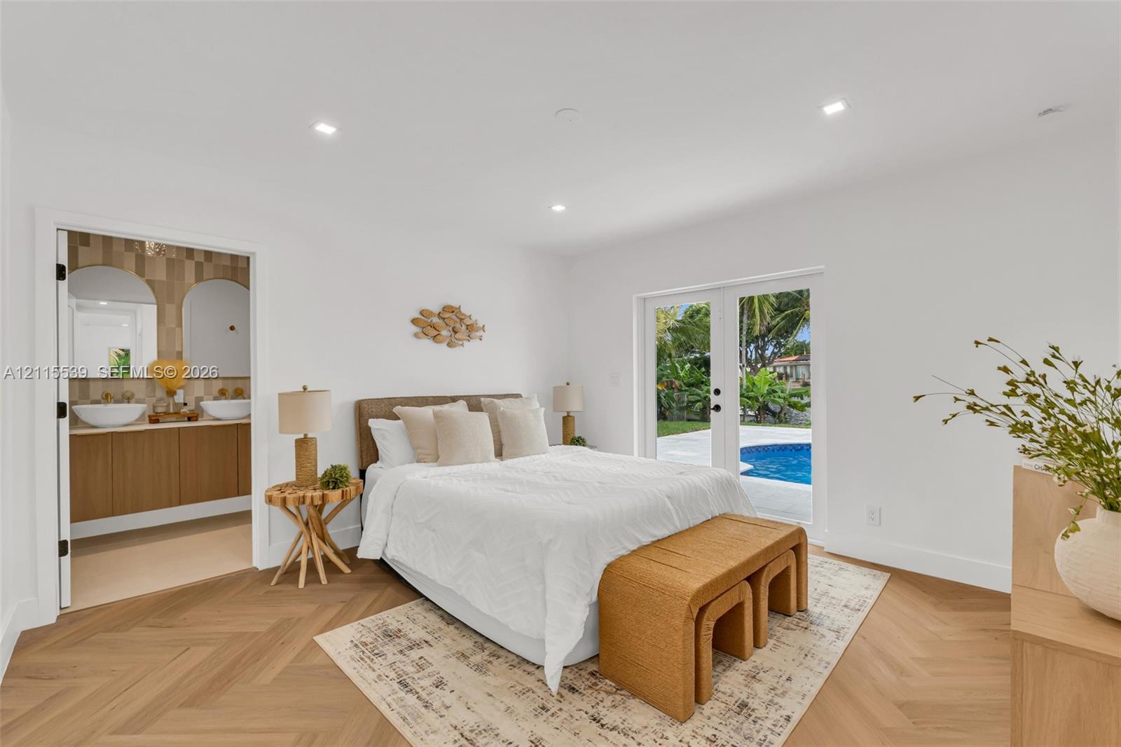 Herringbone-patterned wood-finish flooring, recessed lighting, and glass-paned double doors with exterior pool access