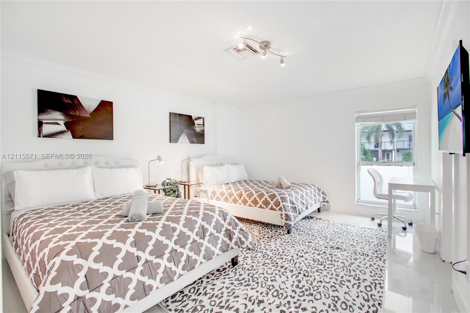 High-gloss tile flooring, crown molding, and a multi-directional adjustable track lighting fixture